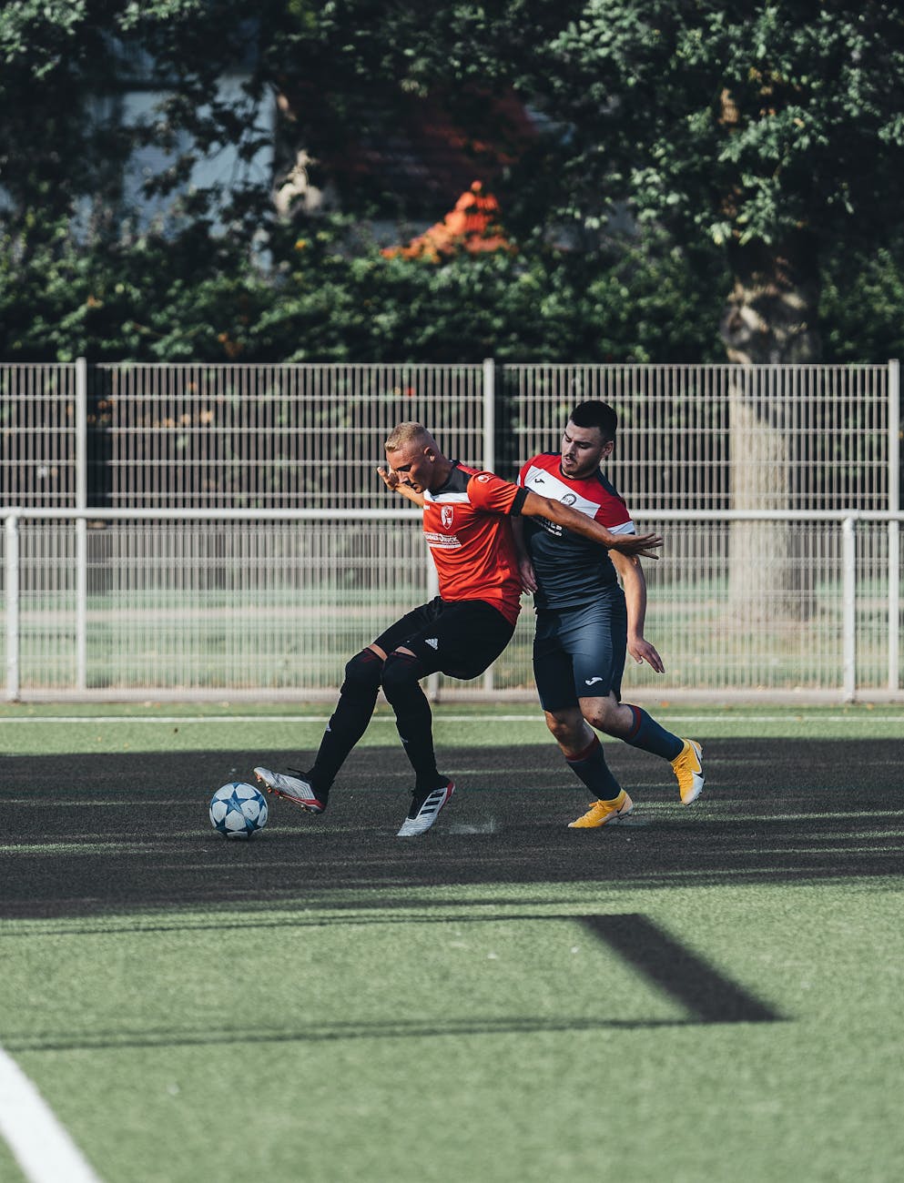 a man defending the ball from his opponent